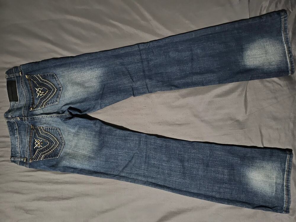 Dark wash embellished denim jeans with contrast stitching and back pocket detail